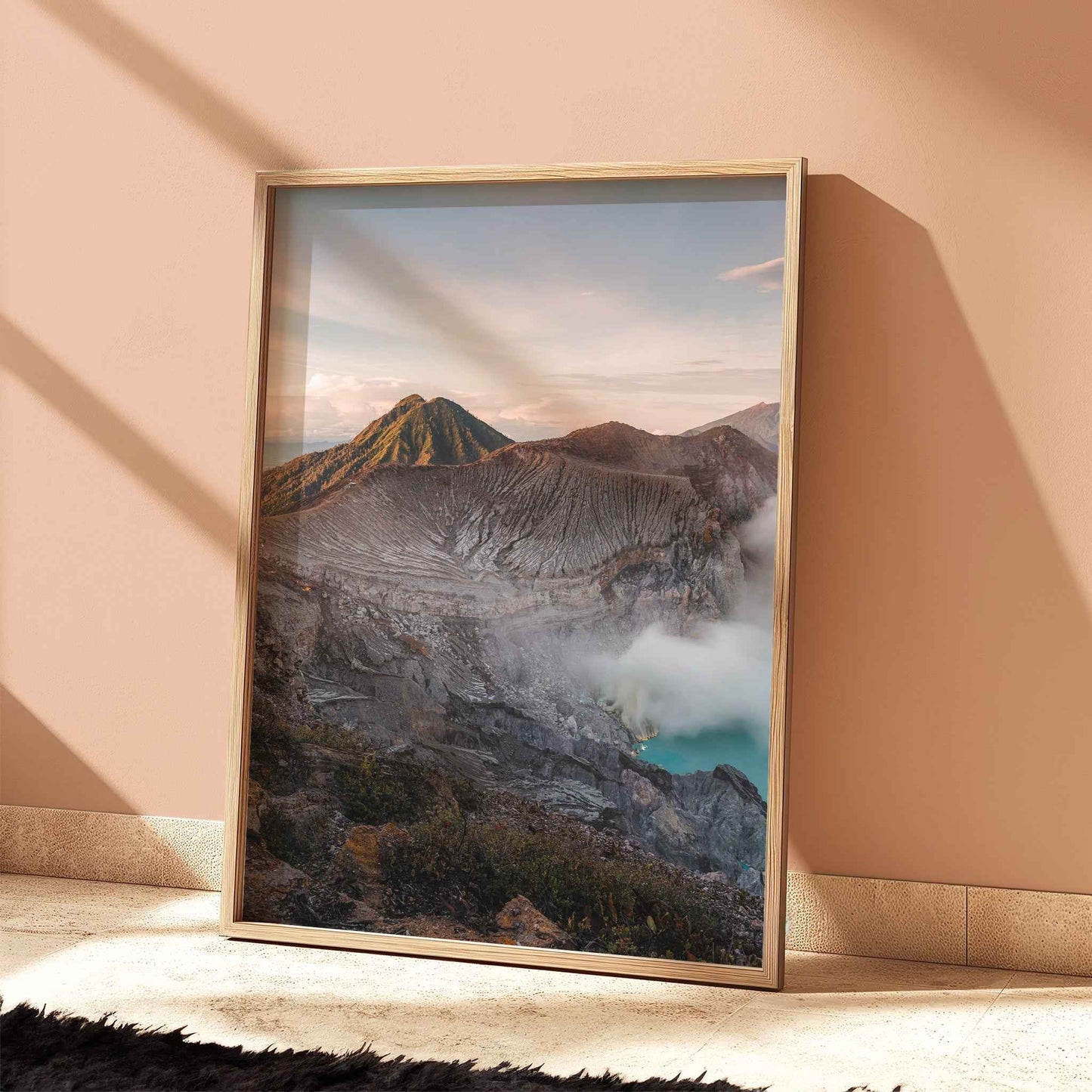 Ijen volcano turquoise crater lake Java Indonesia print in natural wood frame leaning against peach terracotta wall