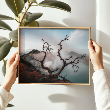Hands holding Ijen volcano dead tree crater lake East Java Indonesia framed wall art print in natural oak wood frame against white wall