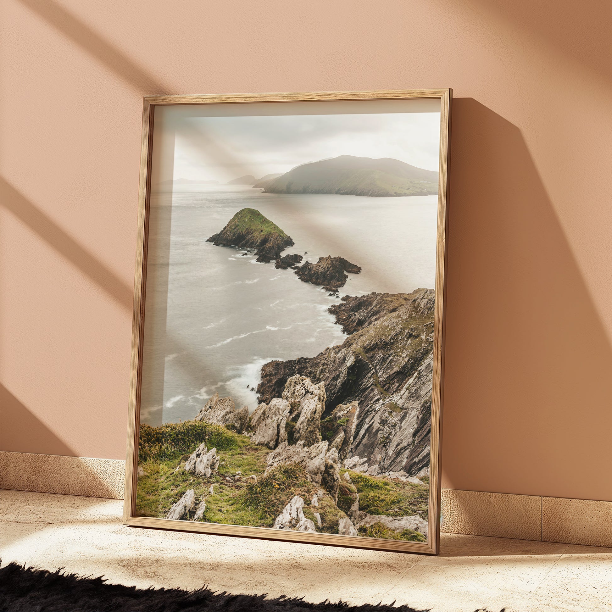 Peaceful Irish coastline photo print with green hills and rocky shoreline