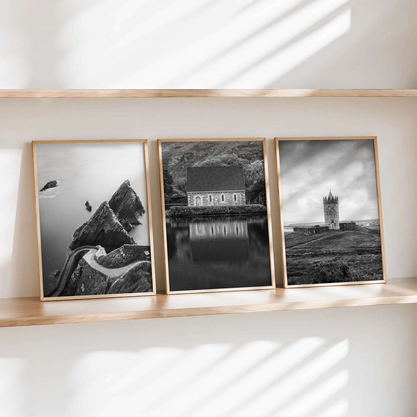 Black and white Irish photography print set of three framed artworks displayed on a floating shelf against a white wall.