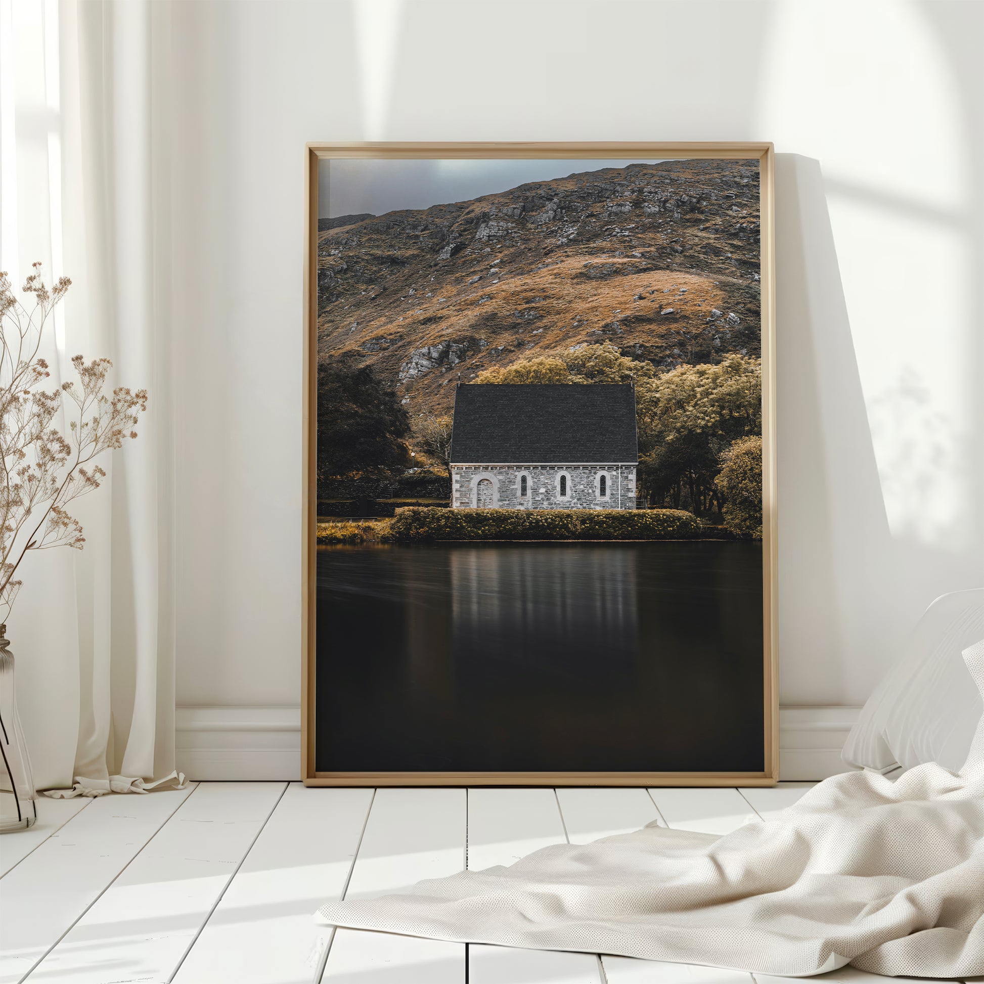 Framed print of Gougane Barra chapel in bright, natural-lit bedroom setting