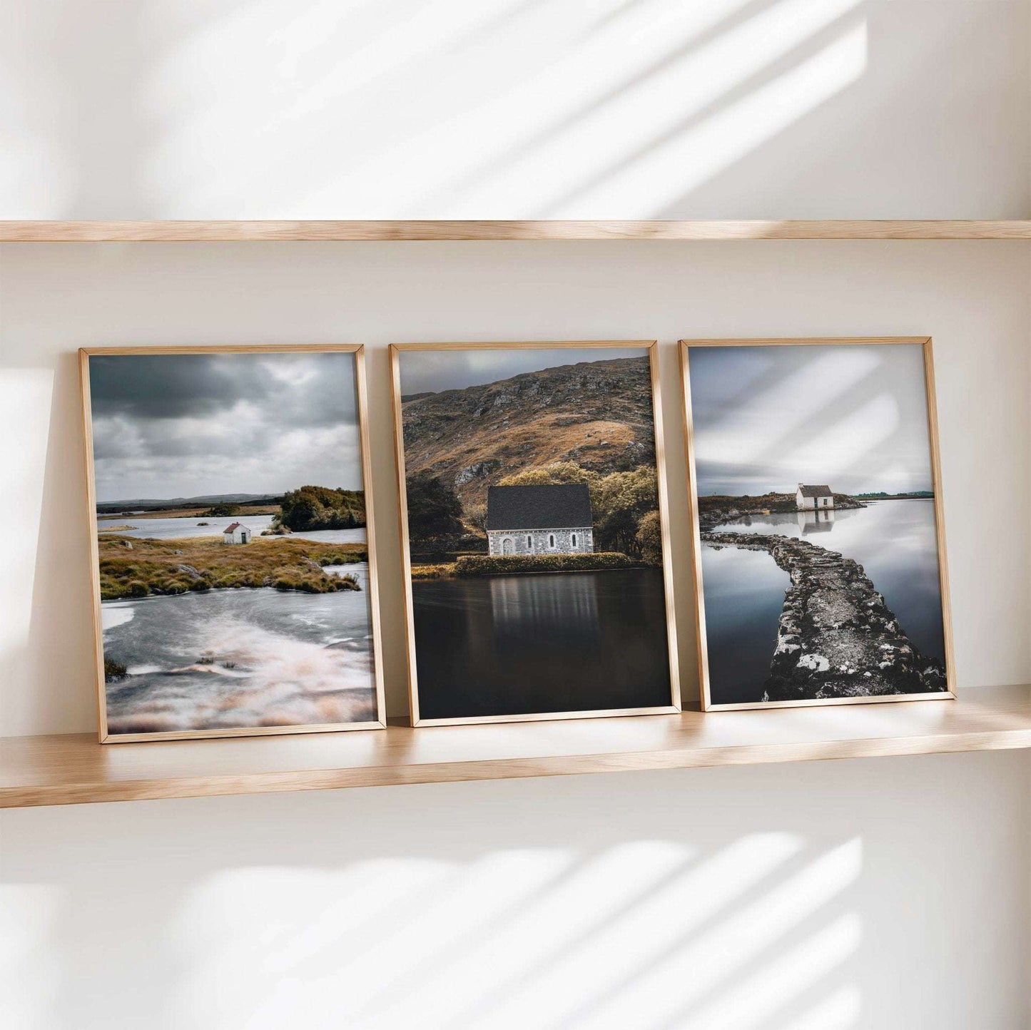Set of three Irish landscape wall art prints arranged side by side, featuring a Connemara hut, Gougane Barra, and a fisherman’s bothy