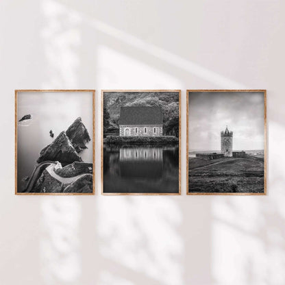 Minimalist display of three black and white Irish landscape prints in wooden frames arranged side by side.