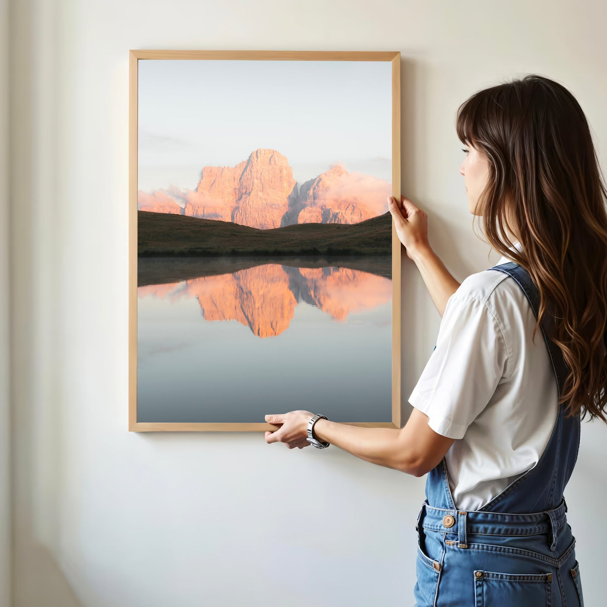 Modern framed Dolomites print being hung on white wall