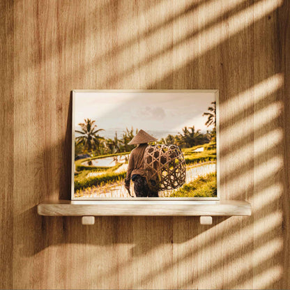 Natural wood framed Jatiluwih Rice Terraces Bali farmer print displayed on a wooden shelf