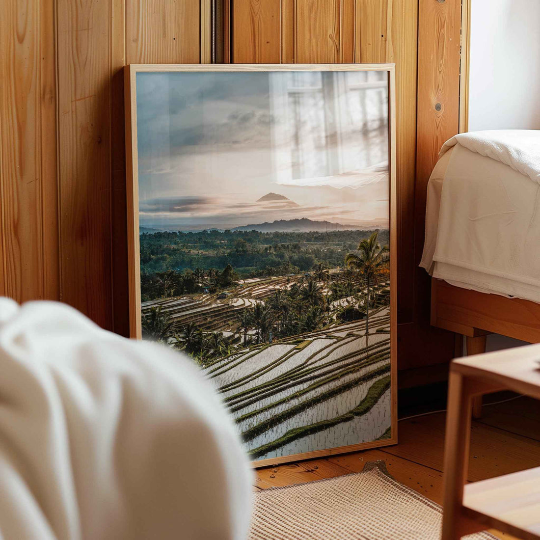 Jatiluwih rice terraces Bali framed photography print leaning against wooden wall in cosy bedroom interior