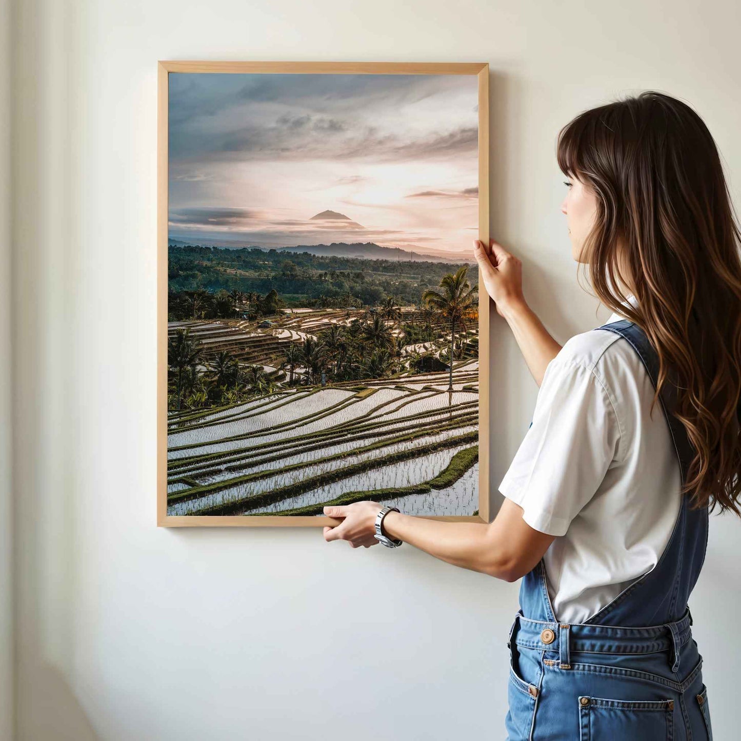 Woman hanging Jatiluwih rice terraces Bali framed wall art print with Mount Agung in natural oak wood frame on white wall