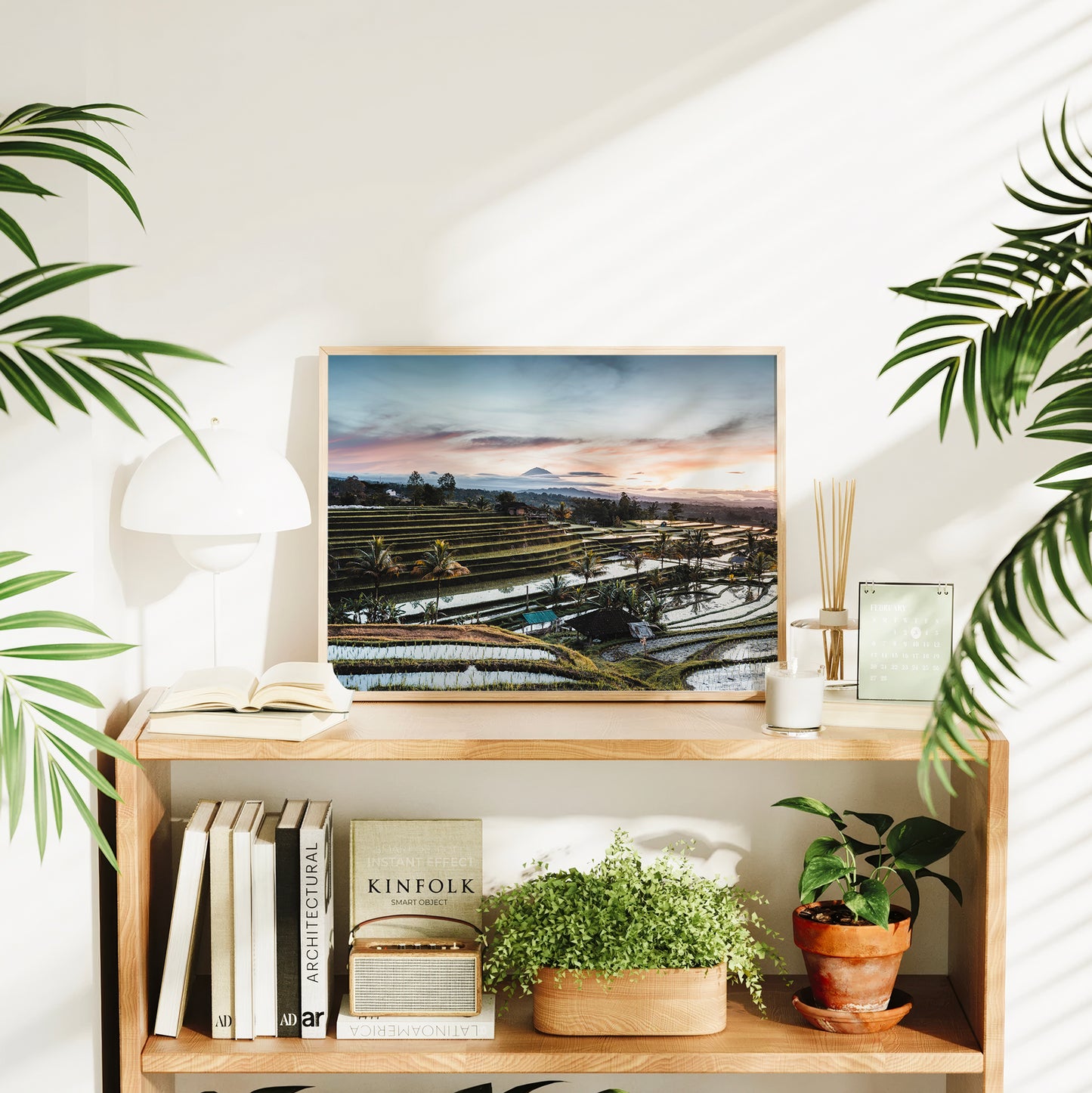 Framed Jatiluwih Rice Terraces sunrise print Bali Indonesia styled on a bookshelf in a bright living room interior