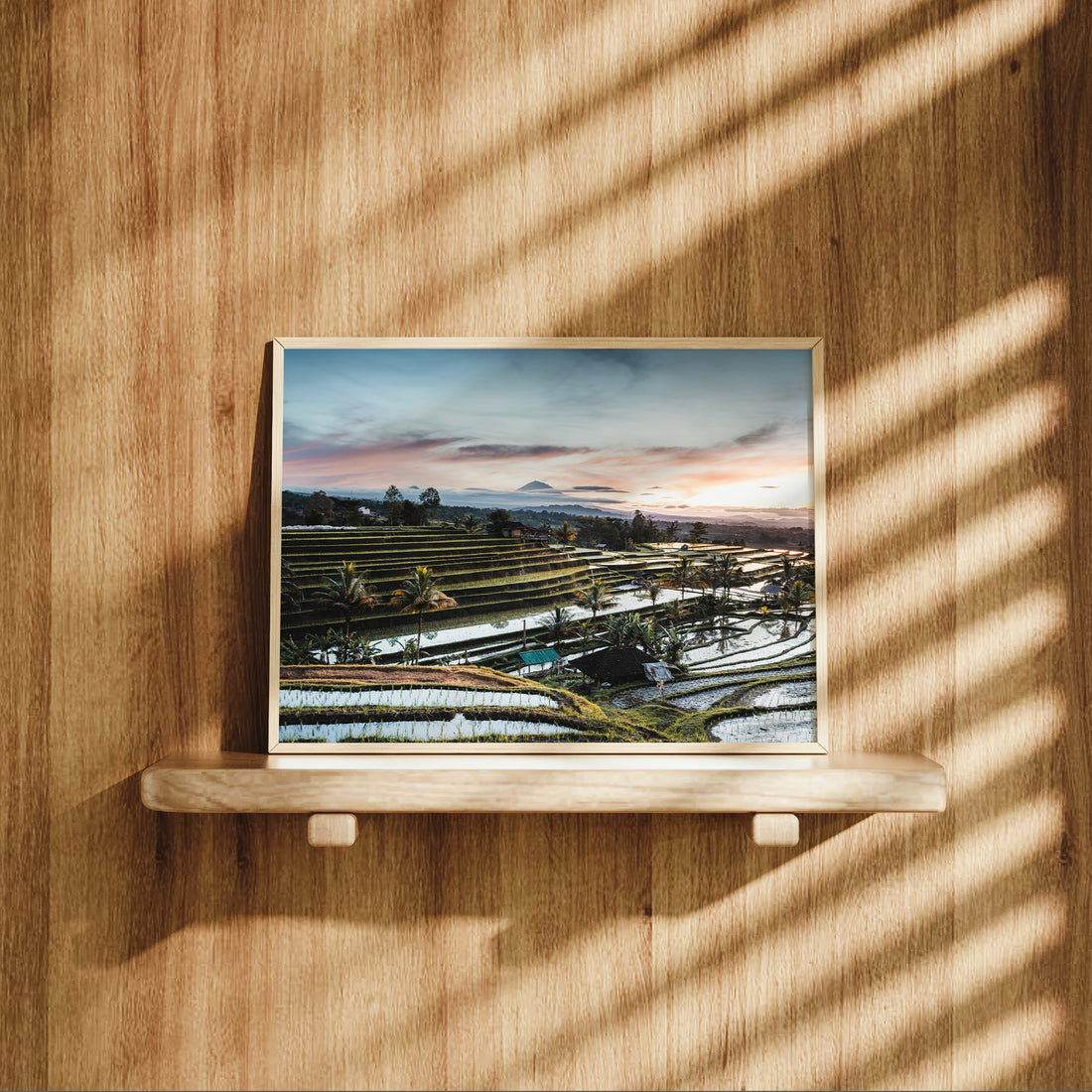 Natural wood framed Jatiluwih Rice Terraces sunrise print Bali Indonesia displayed on a wooden shelf