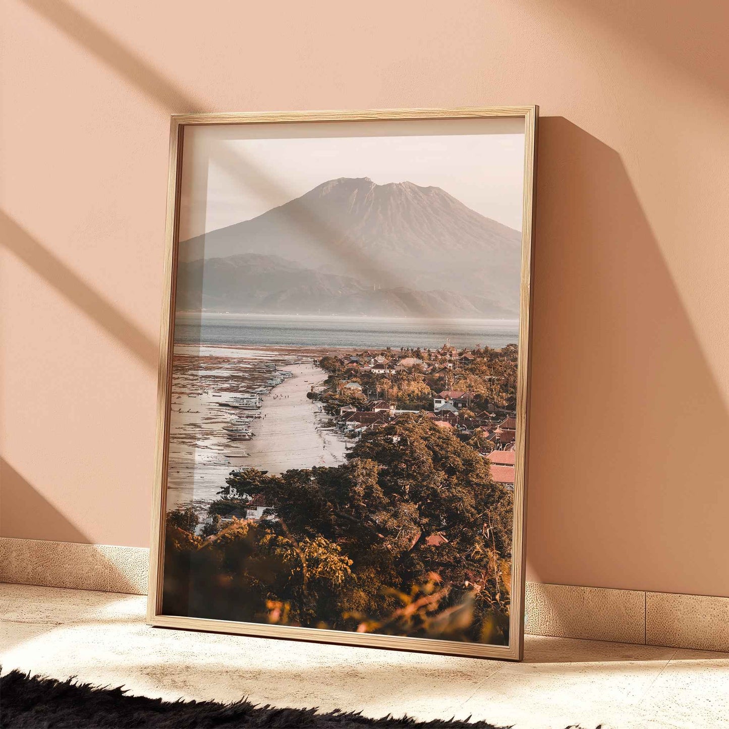 Jungutbatu Beach Nusa Lembongan Mount Agung travel print in natural wood frame leaning against peach terracotta wall
