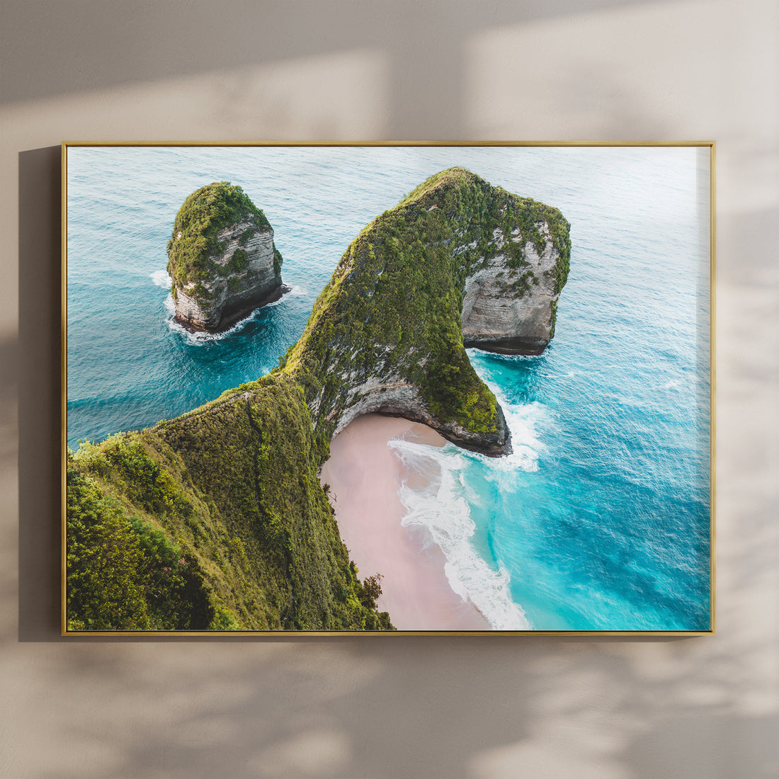 Framed aerial print of Kelingking Beach Nusa Penida Bali in a gold float frame mounted on a wall