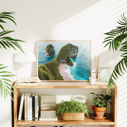 Framed Kelingking Beach Nusa Penida Bali aerial print styled on a bookshelf in a bright living room interior
