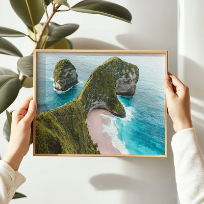 Person holding a natural wood framed print of Kelingking Beach Nusa Penida Bali aerial drone photo