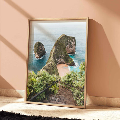 Kelingking Beach Nusa Penida travel print in natural wood frame leaning against peach terracotta wall