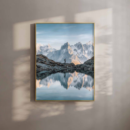 A breathtaking view of Lac Blanc with the reflection of the Aiguilles de Chamonix in the calm water at sunset.