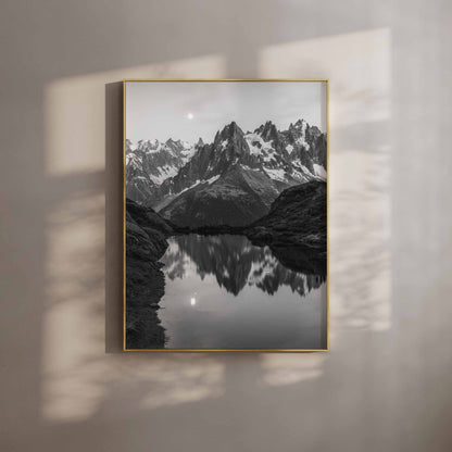 Black and white photo of Lac de la Flégère in Chamonix reflecting dramatic peaks under moonlight.