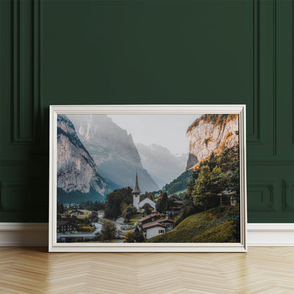 Lauterbrunnen village church nestled between majestic mountains and a lush green landscape.