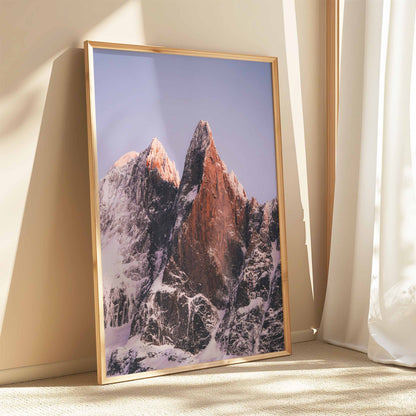 Snowy Les Drus peaks bathed in soft evening light, framed by the serene alpine winter.