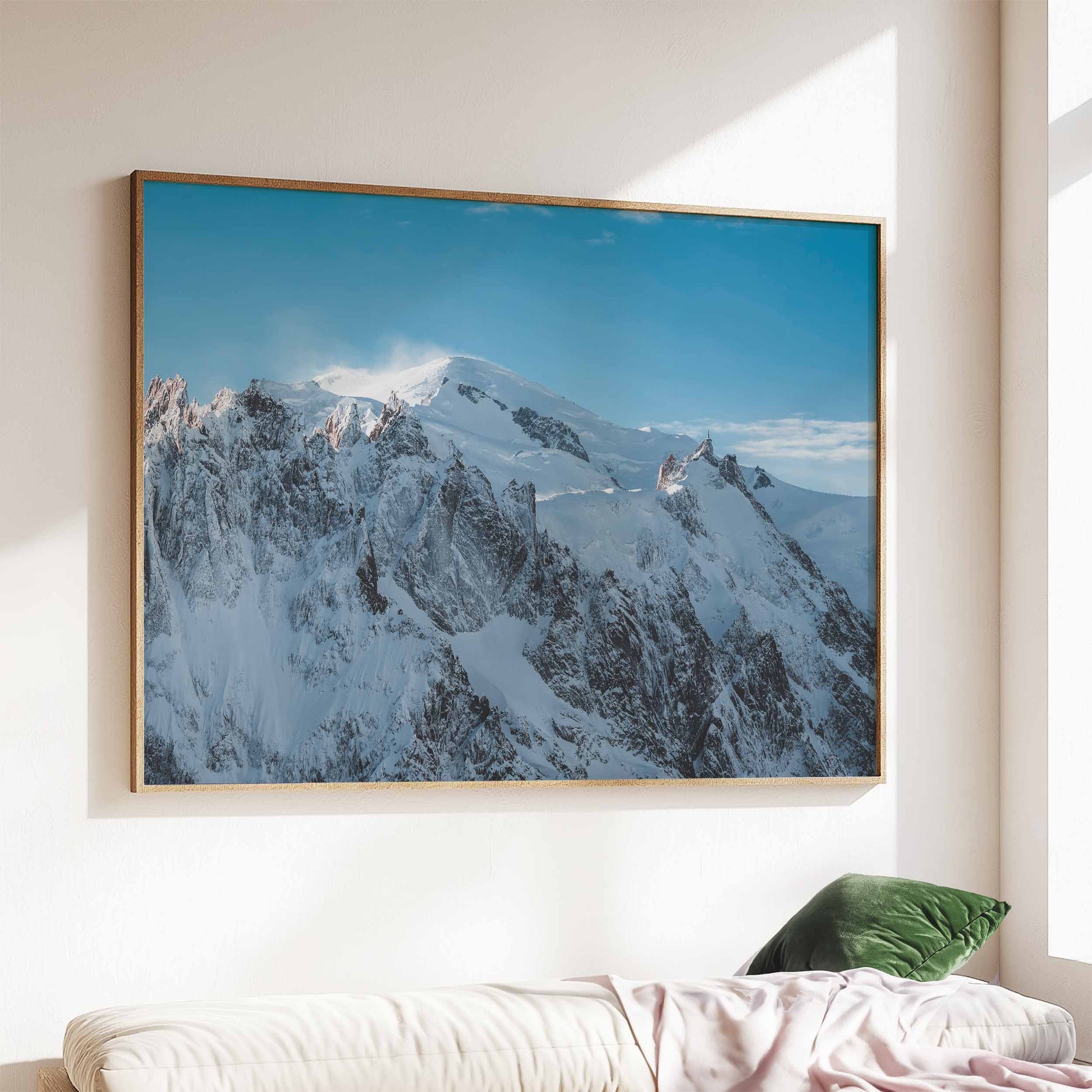 Large framed Massif du Mont Blanc artwork in a minimalist living room, illuminated by natural light.