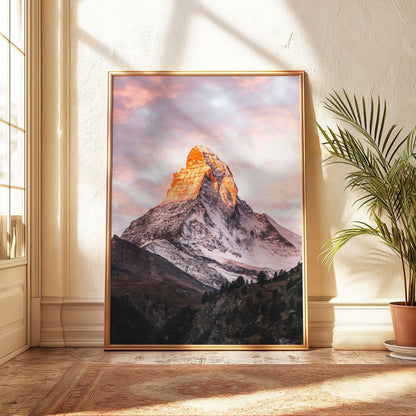 The Matterhorn at sunrise, bathed in alpenglow, with a light gold frame and soft natural lighting.