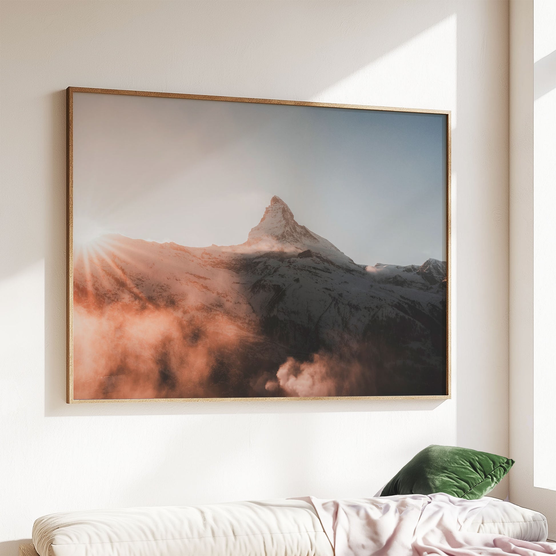 Framed Matterhorn sunset print styled above a sofa in soft evening light.