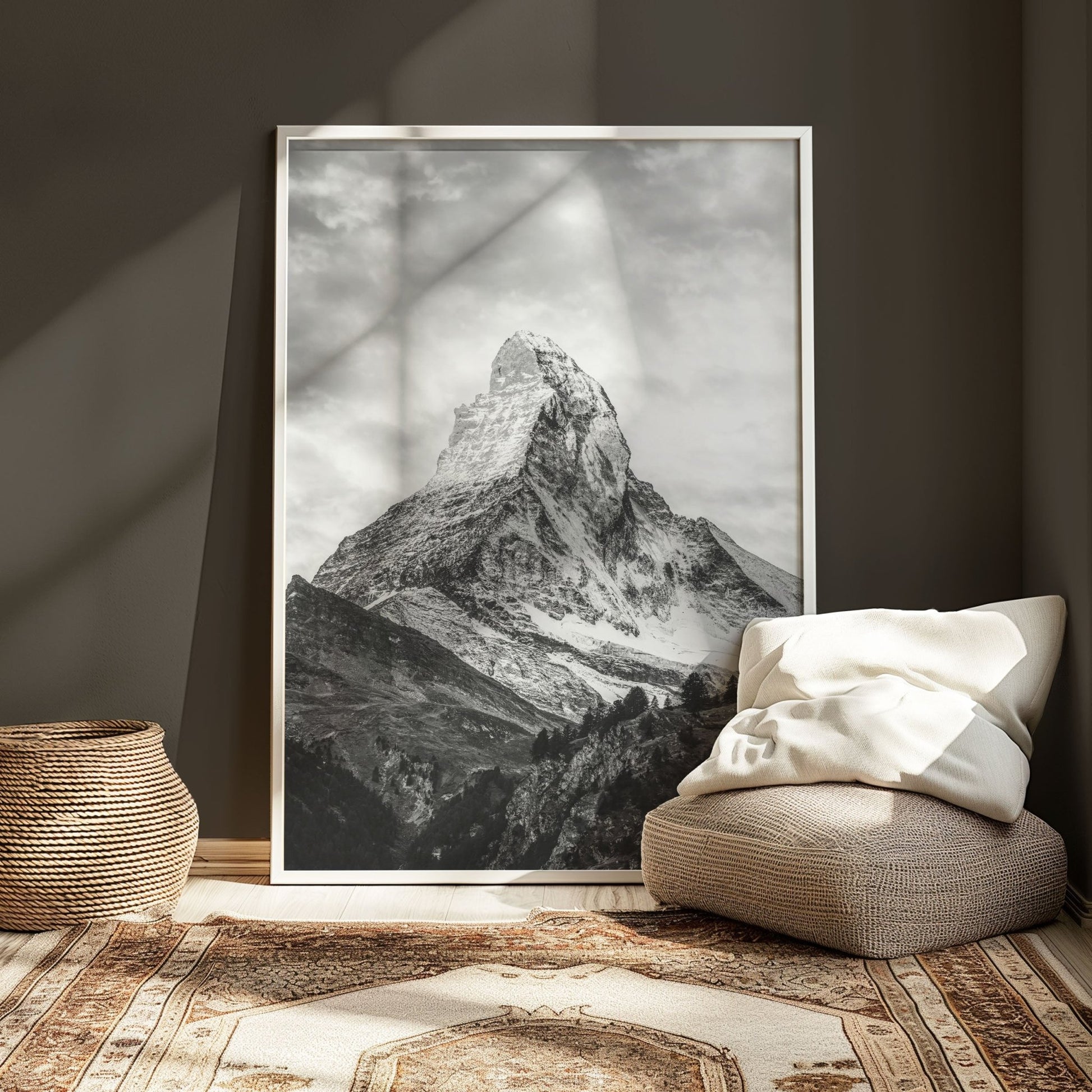 Black and white Matterhorn photo leaning against a dark wall with cosy neutral decor.