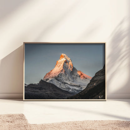 Matterhorn sunrise print leaning against a bright wall, capturing alpine beauty.