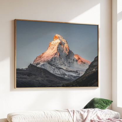 Morning light on the Matterhorn, framed and displayed above a modern sofa.