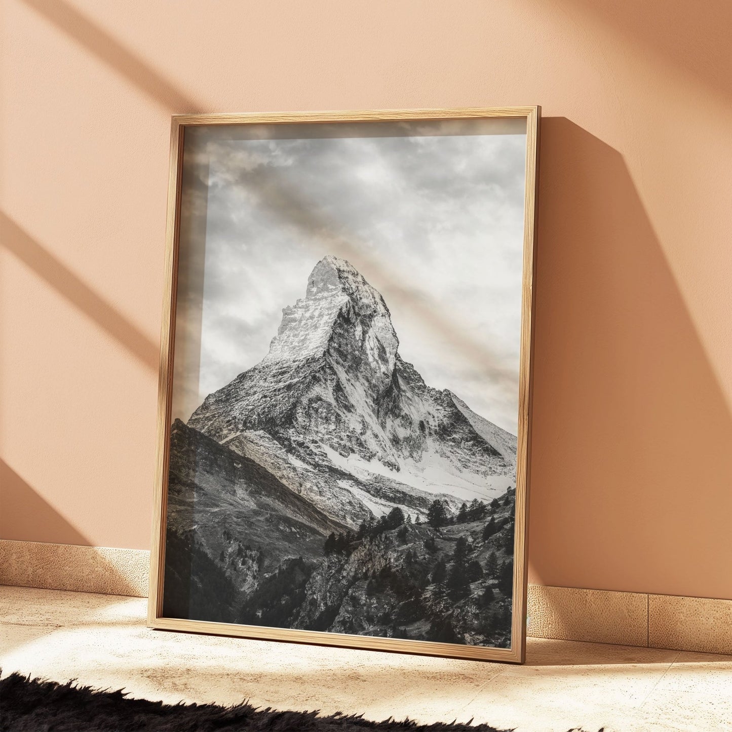 Rustic oak-framed photo of the Matterhorn, propped against a peach wall with a warm ambiance.