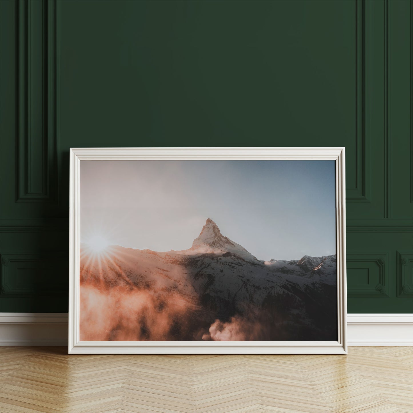 Matterhorn mountain print with glowing sunset hues, displayed against a deep green wall.