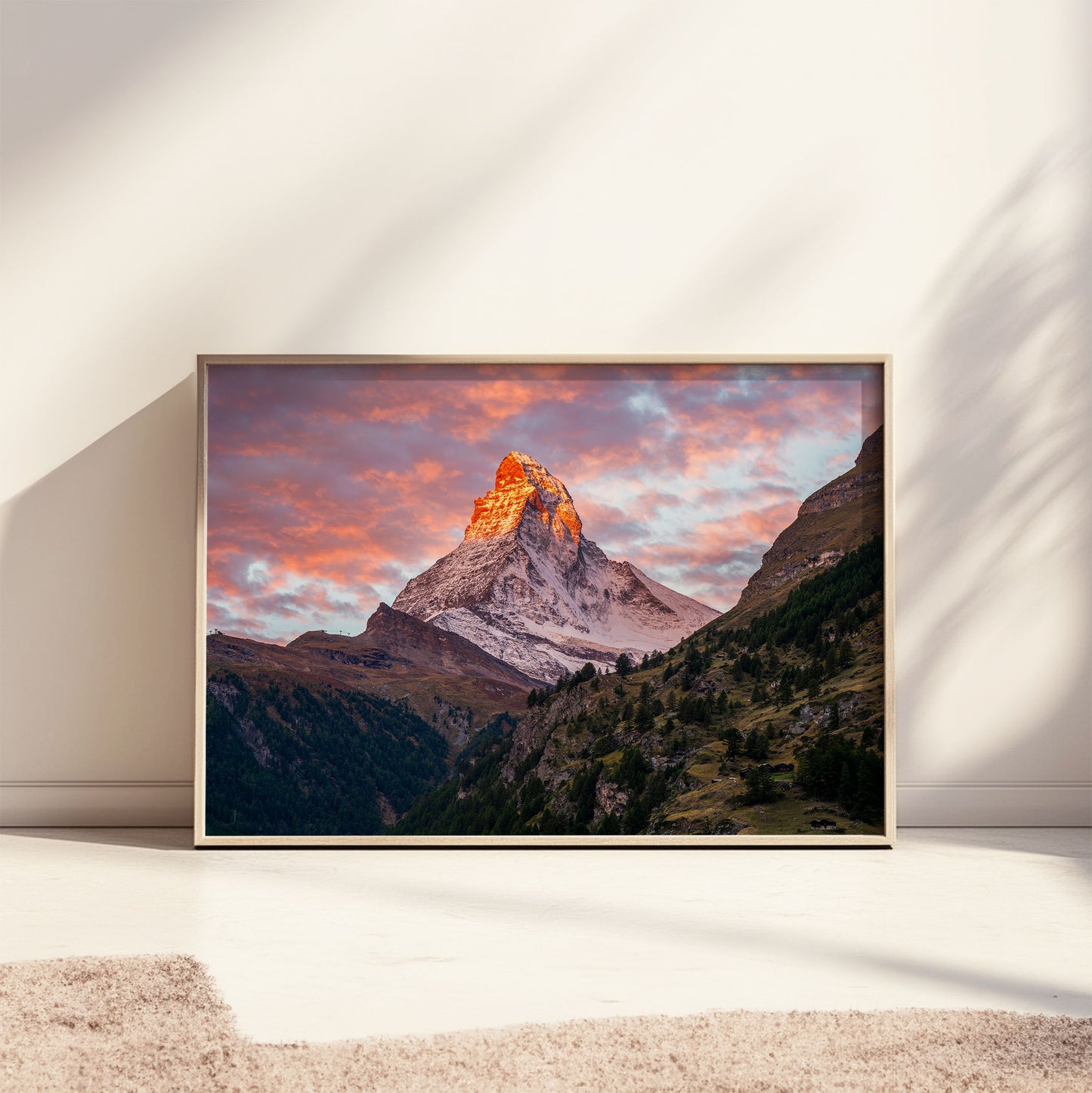 Matterhorn sunset wall art leaning against a sunlit wall, highlighting the vivid sky and peaceful alpine landscape.