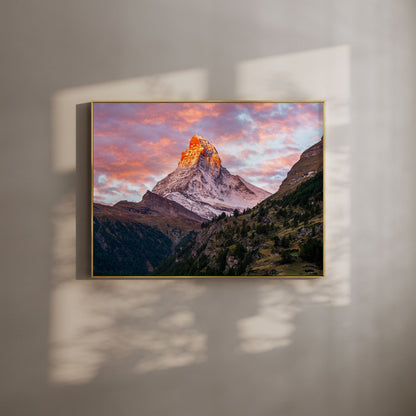 Matterhorn mountain glowing in a vibrant sunset with pink and orange clouds, perfect for nature-inspired wall art.