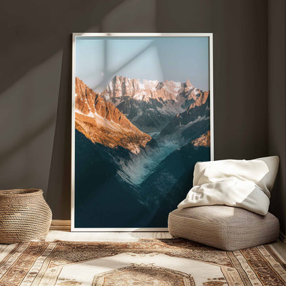 Alpine landscape with Mer de Glace glacier and dramatic mountain peaks under a soft glow.