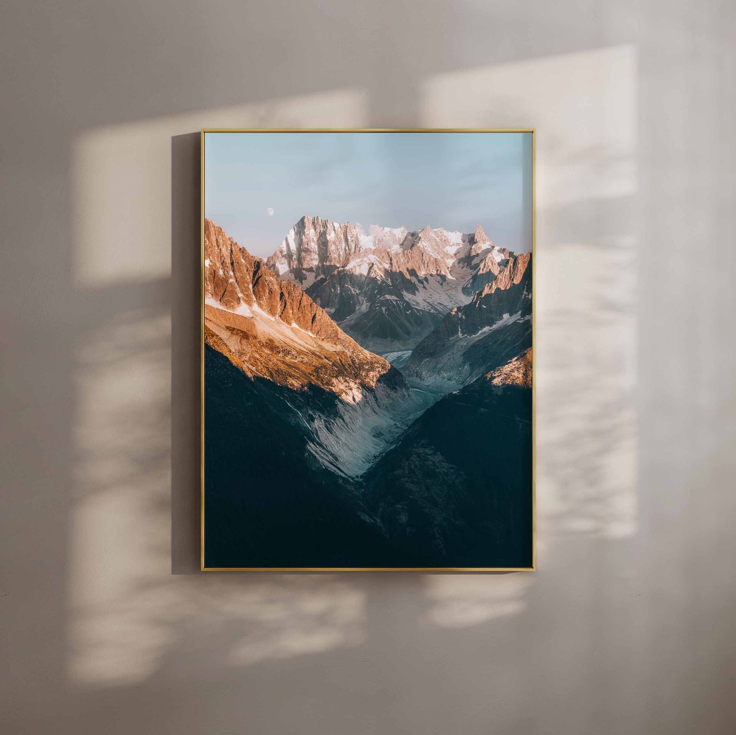 View of Mer de Glace glacier framed by sunset-lit mountains in Chamonix, France.