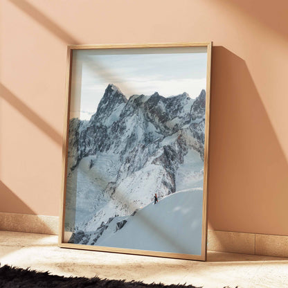 Winter alpine adventure with a skier on the Midi Arete, wall art showcasing mountain serenity in a light wooden frame.