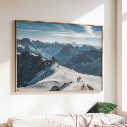 Two climbers trekking the snowy Midi Arête, photographed with majestic alpine peaks in the background.