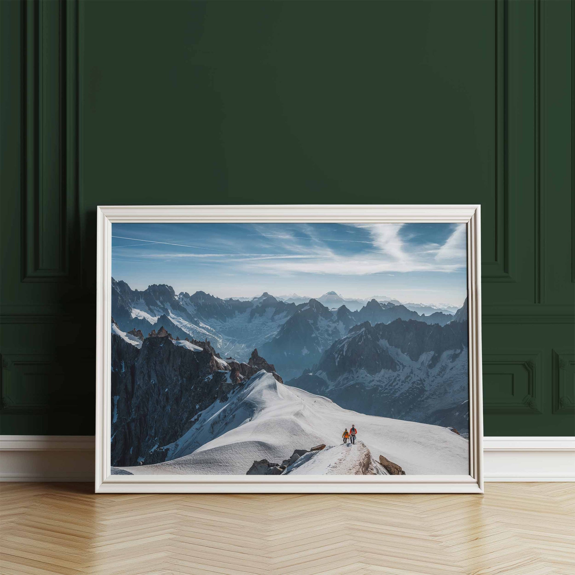 Snow-covered Midi Arête with two climbers descending, framed wall art on display against a green wall.