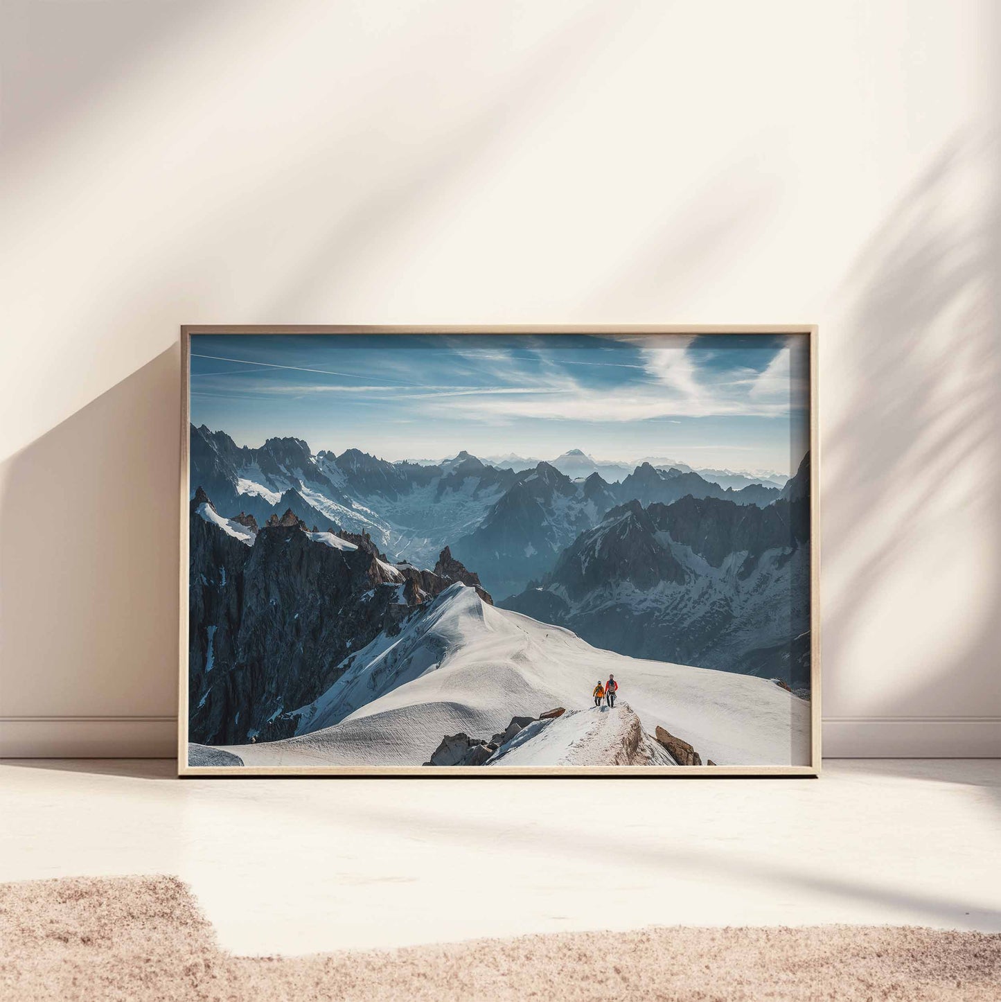 Brightly lit alpine scene of climbers on the Midi Arête with the expansive French Alps in view.