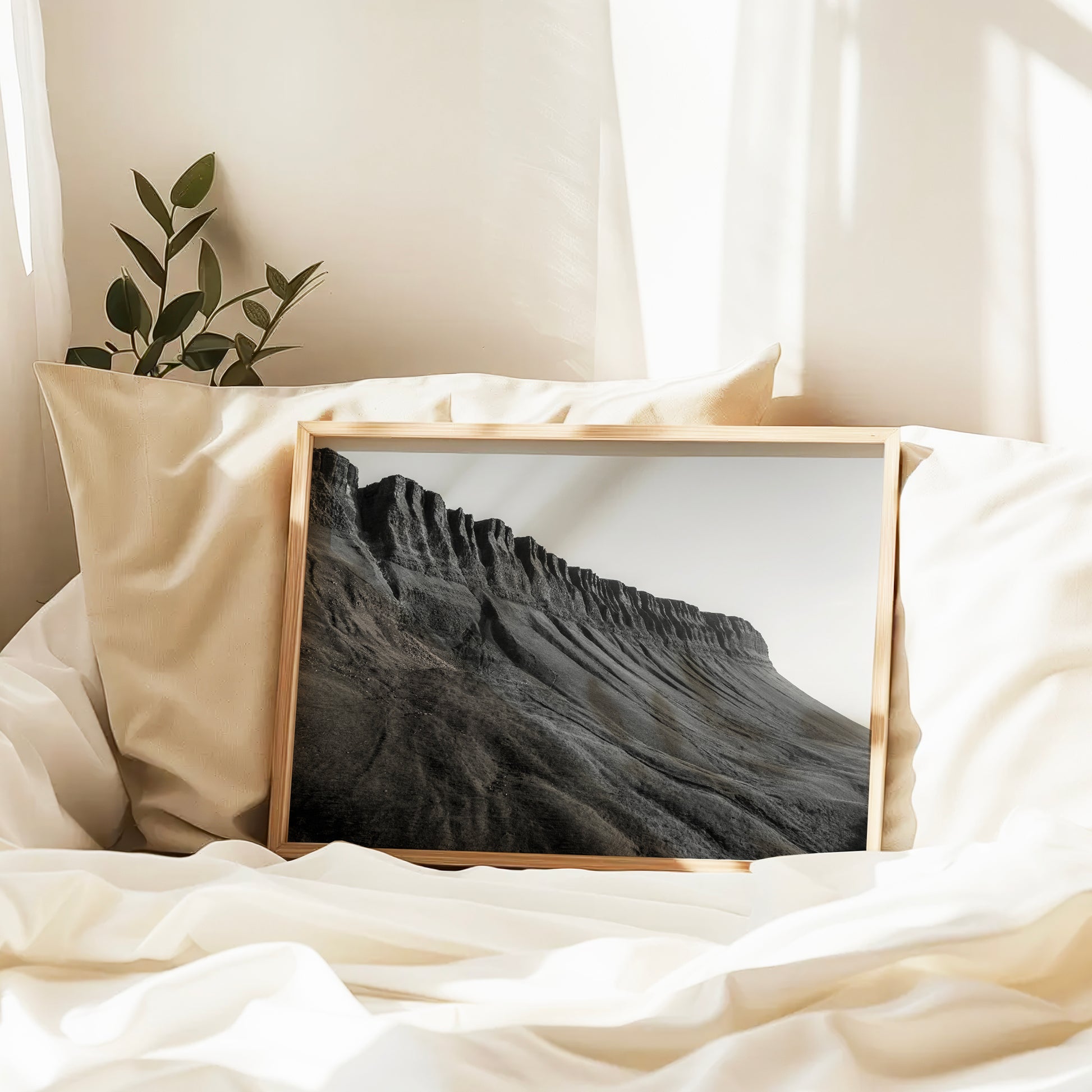 Black and white Benbulbin print on soft white bedding in natural light
