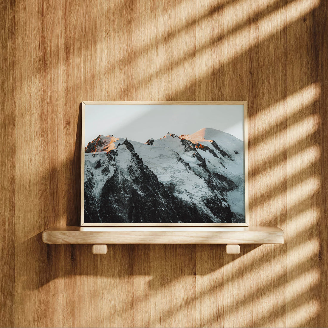  Landscape photo of the Mont Blanc Massif bathed in alpine light with sharp peaks and glacial shadows.