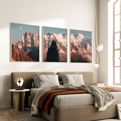 Set of three Mont Blanc wall art prints displayed above a modern bed in a cozy bedroom.