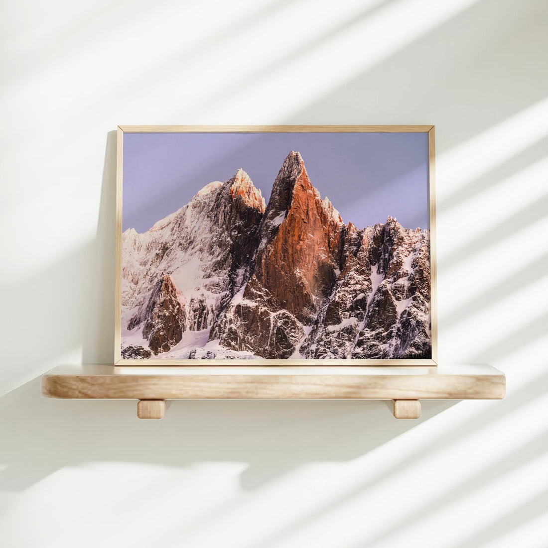 Fine art photography print of the Mont Blanc range with Les Drus bathed in sunrise glow—captured from Chamonix valley.