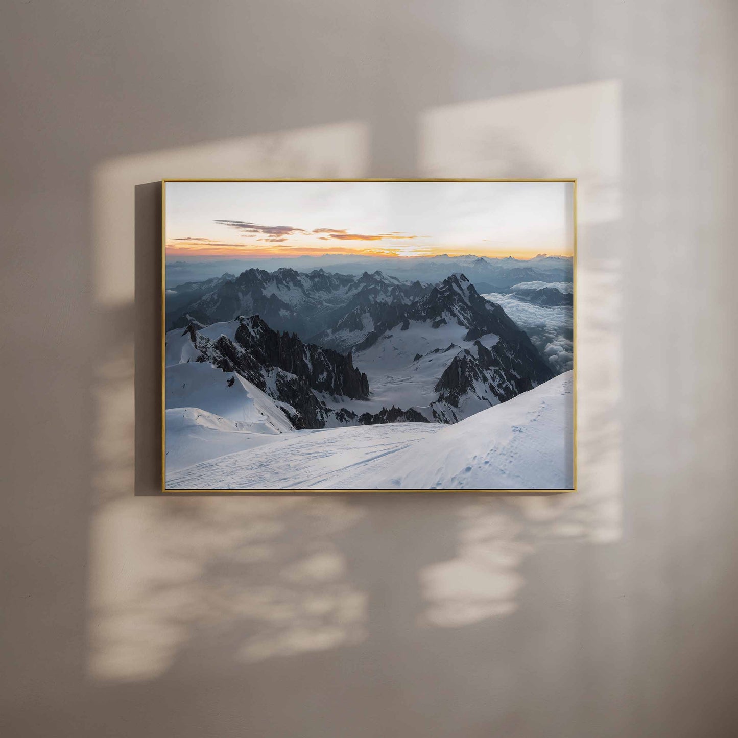 Dramatic view of snow-covered peaks from Mont Blanc summit framed in sunlight