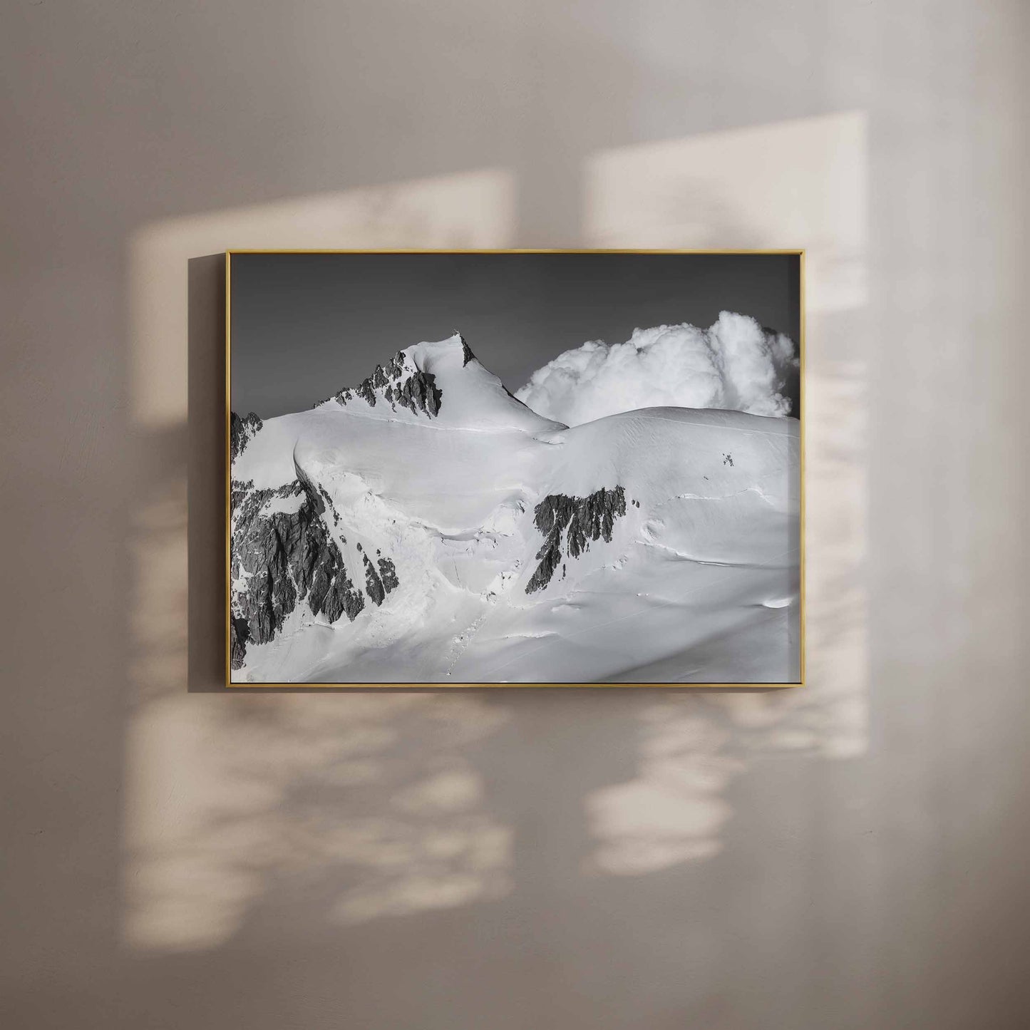 Black and white photograph of Mont Maudit in Chamonix with dramatic clouds and snow-covered peaks in a gold frame.