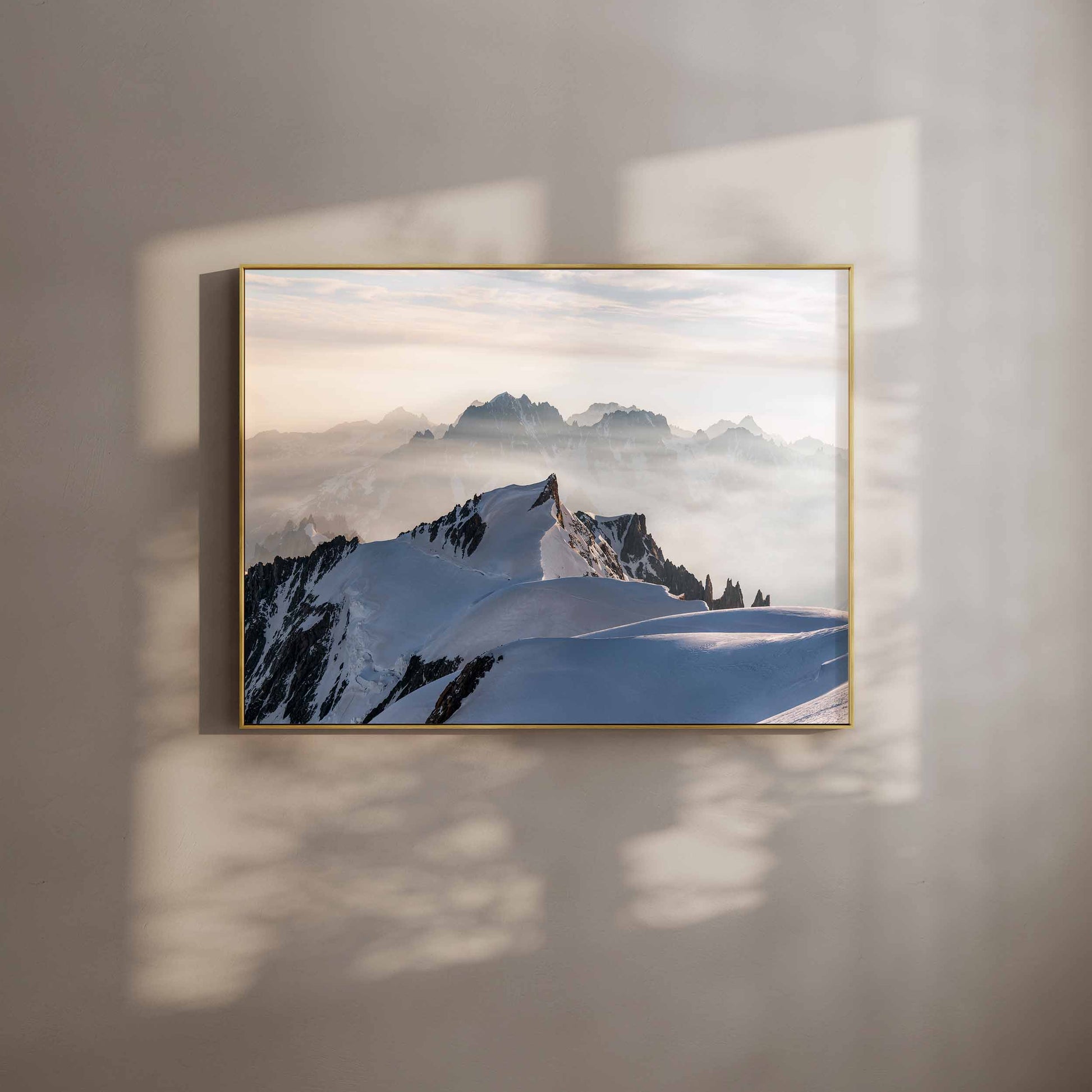 Mont Maudit summit view from Mont Blanc framed wall art in a minimalist room with shadows.