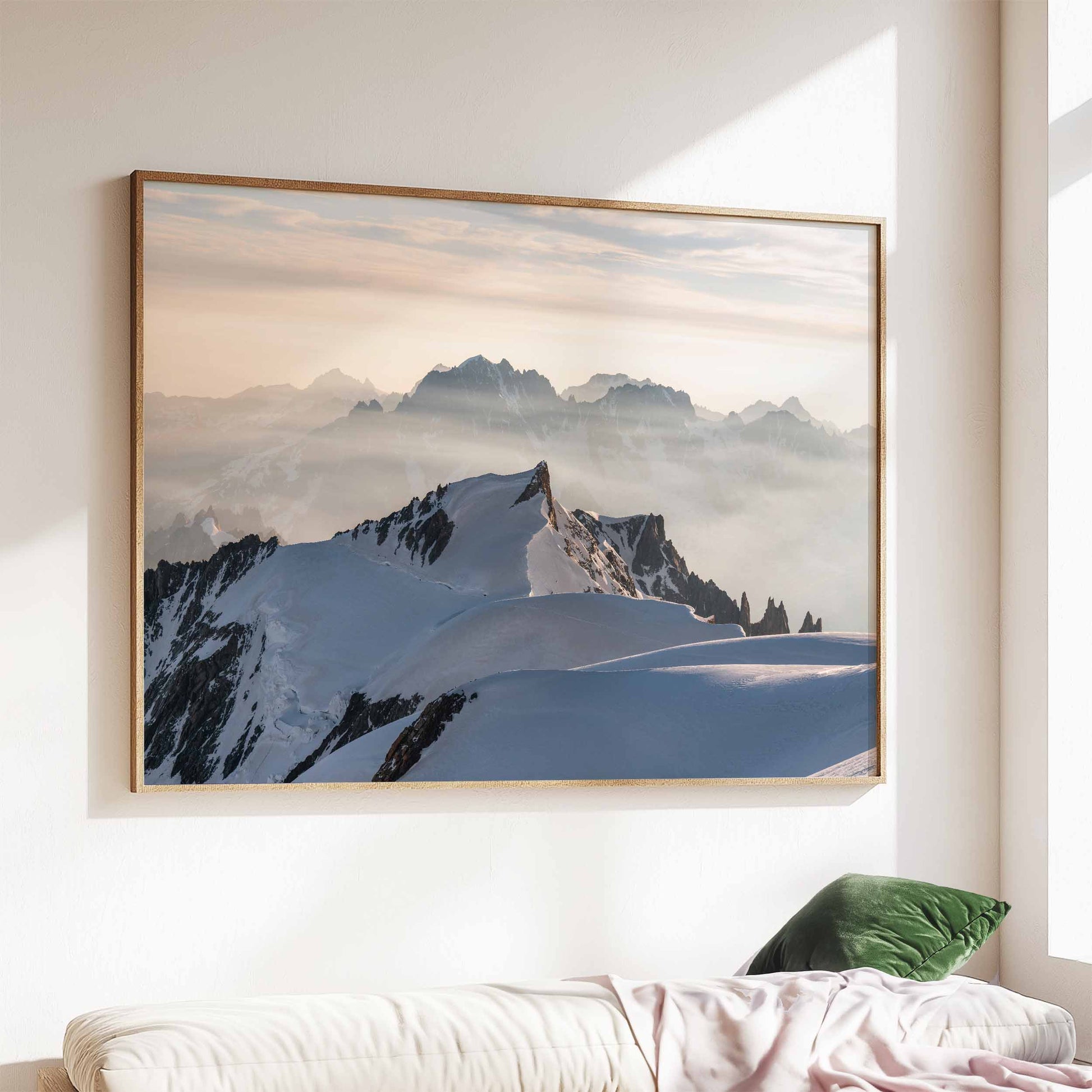 Mont Maudit summit with sunlight, snowy peaks, and a green sofa in a cozy interior.