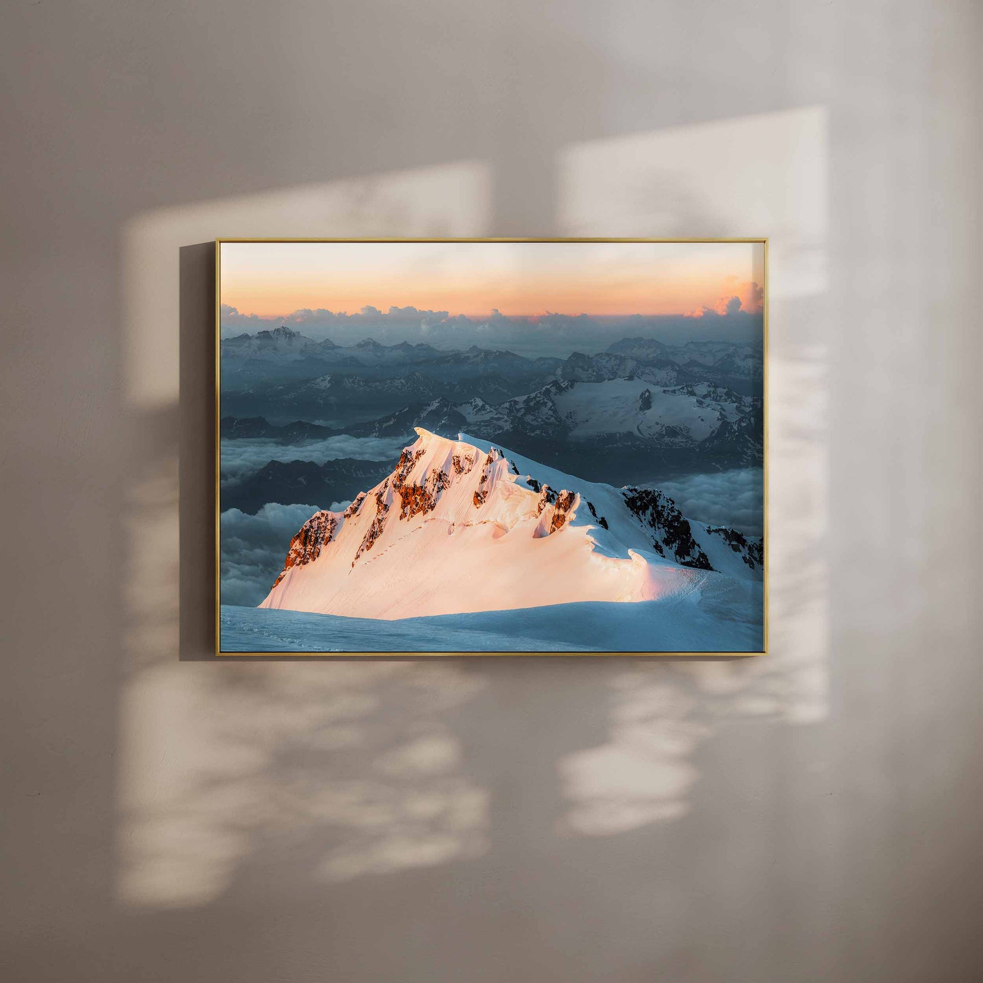 Monte Bianco di Courmayeur lit by soft sunrise light, viewed from the summit of Mont Blanc, displayed in a golden frame.