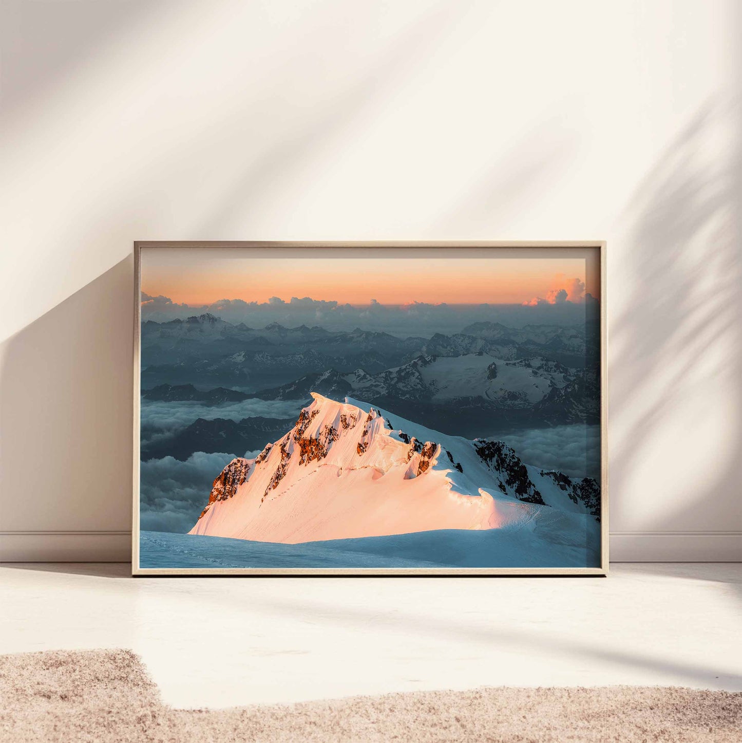 Monte Bianco's sharp peak glowing with morning light, framed and styled against a modern dark green wall.