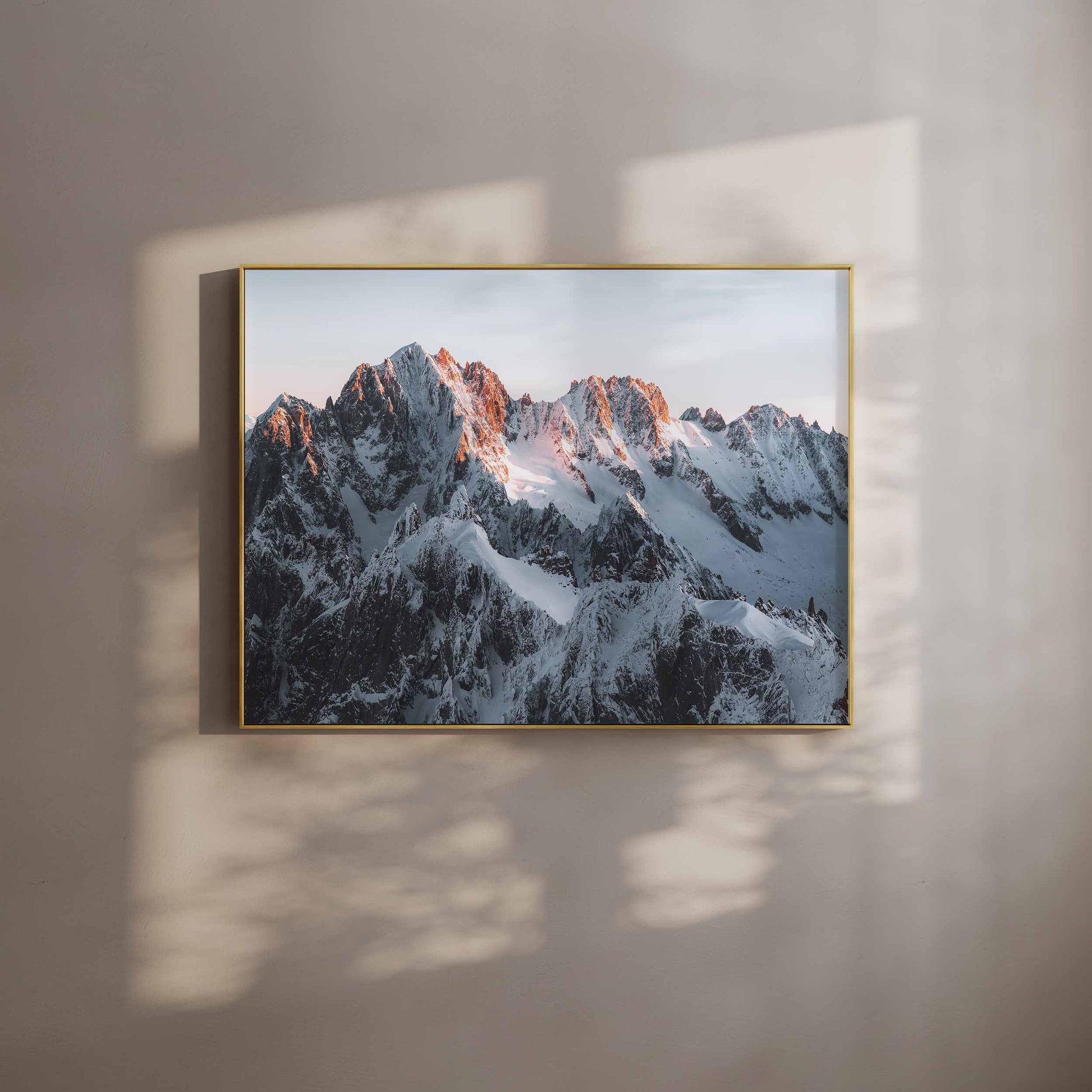 Warm-toned mountain wall art featuring Chamonix peaks in soft interior lighting