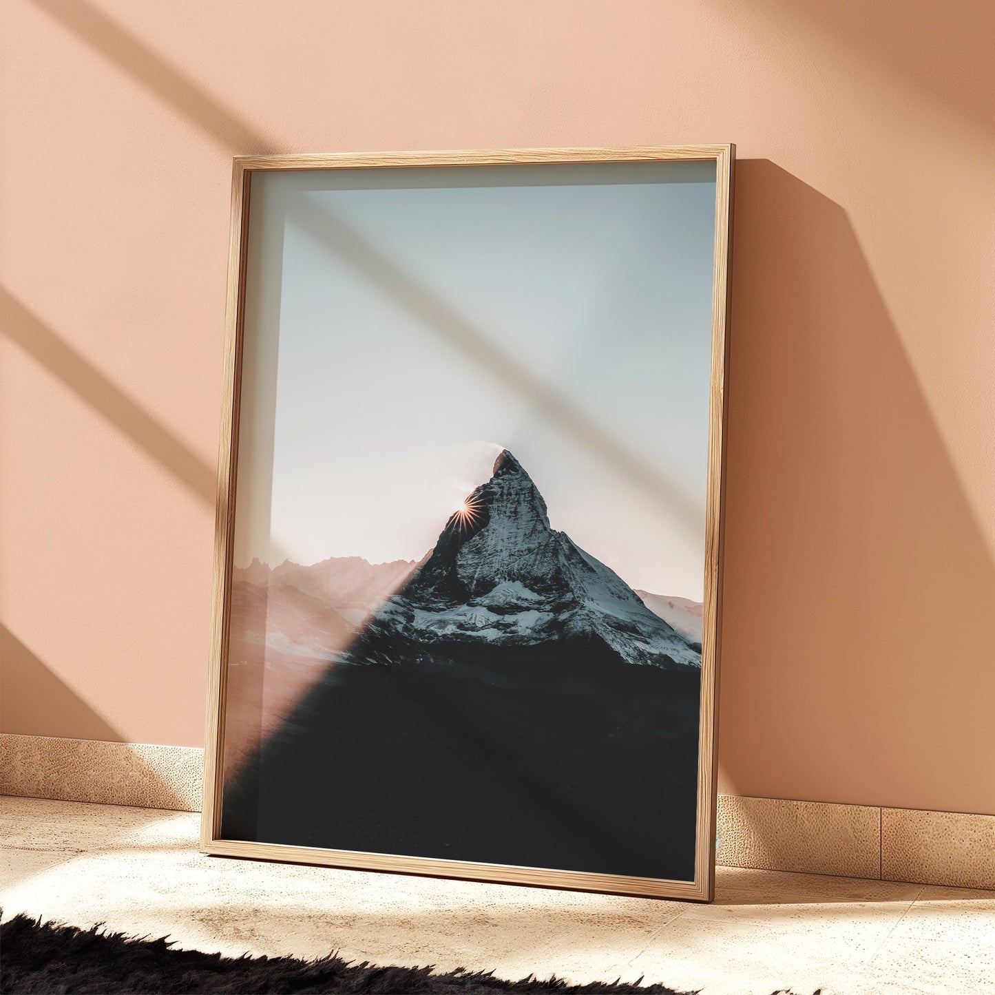 Matterhorn wall art leaning against peach wall with bold shadow line